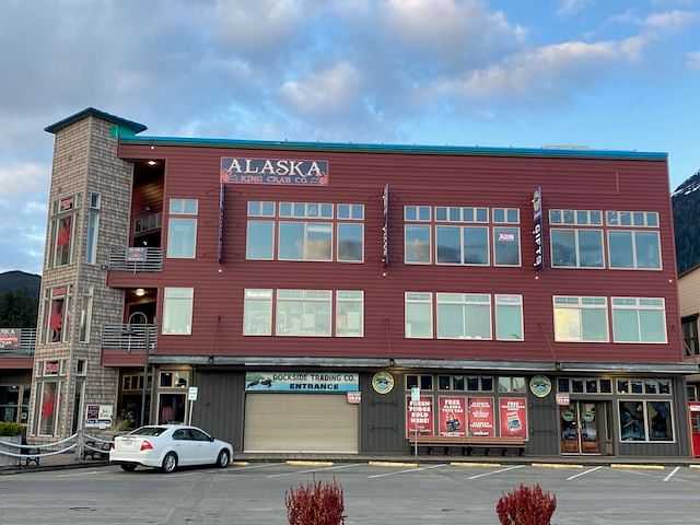 A three-story building in Alaska with a seafood restaurant on the top floor and trading co. entrance below.